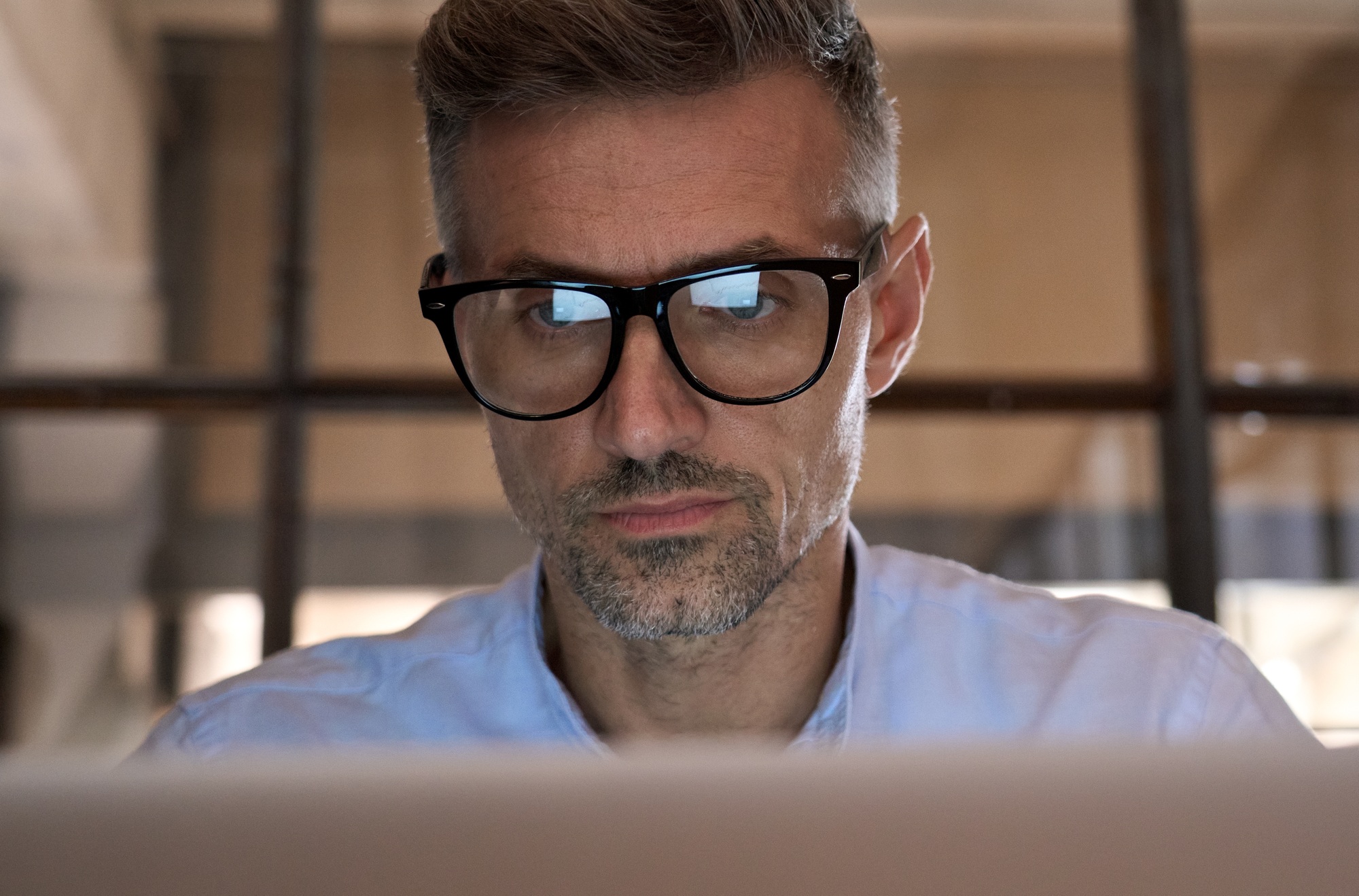 concentrated-business-man-looking-at-computer-screen-reflecting-in-glasses-.jpg