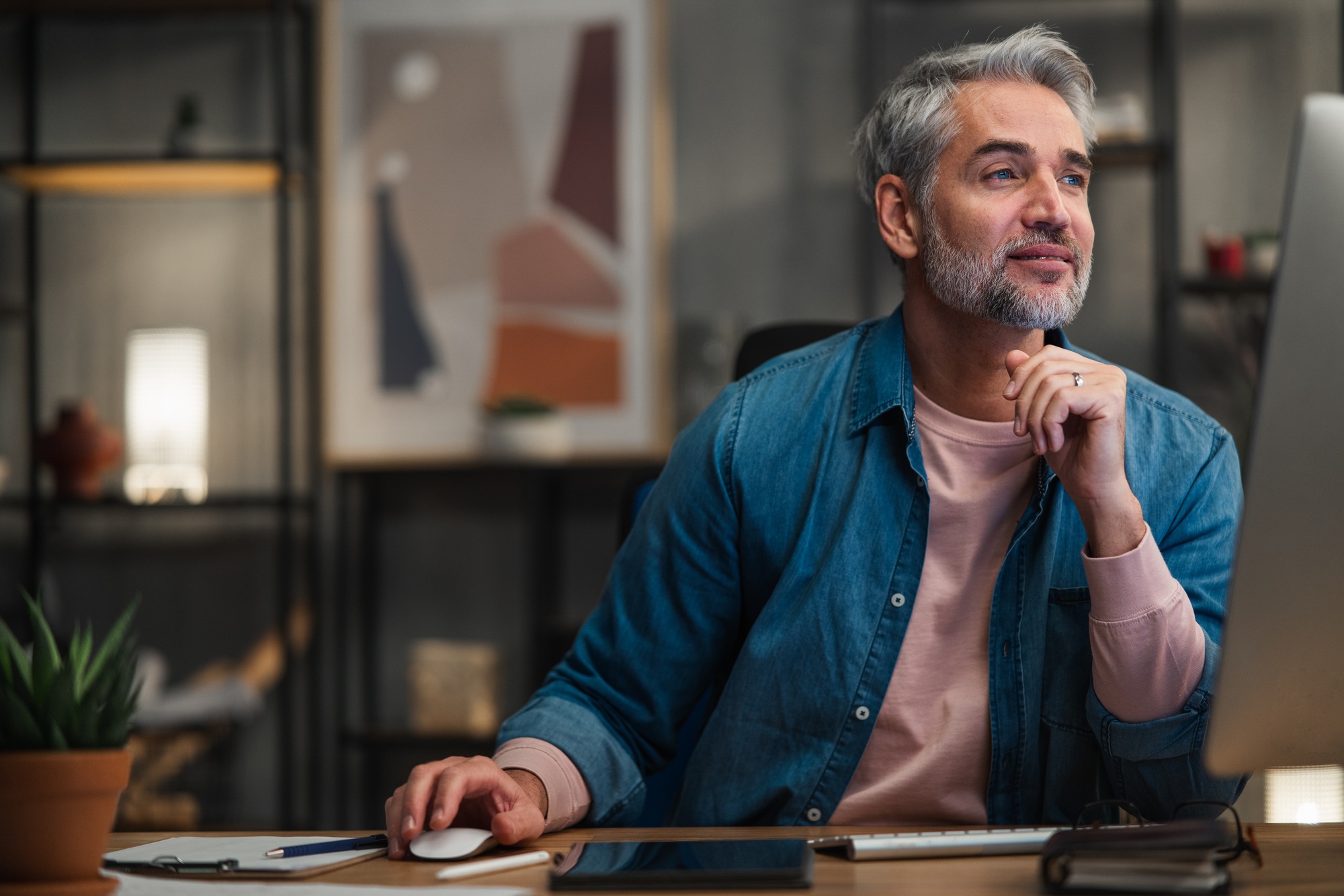 man working on a computer looking at options for hoa management marketing